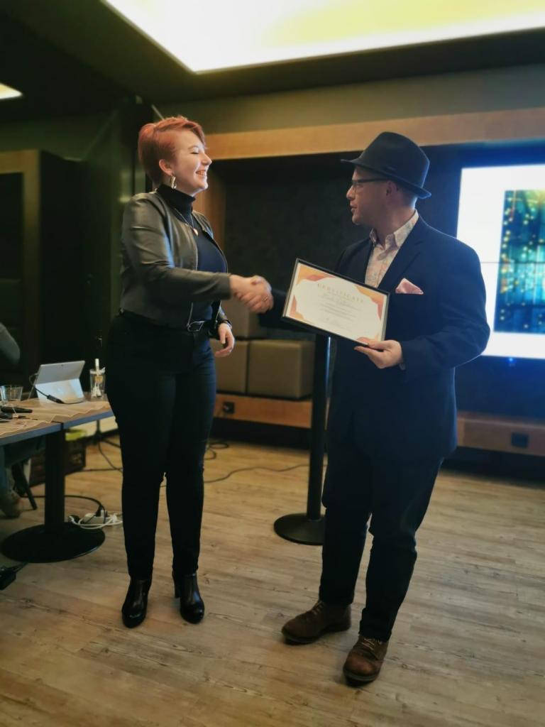 Noora Yliviikari, Chair of SeiES, presenting Mark Wiltshear with award certificate